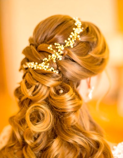 Elegant bridal hairstyle with pearl and gold vine accessory