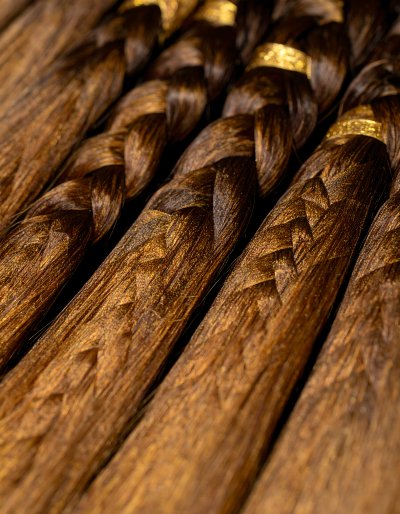 Braided hair extensions with luxurious gold accents