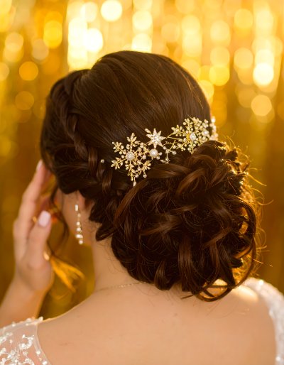 Elegant bride's updo, gold accessory, golden bokeh