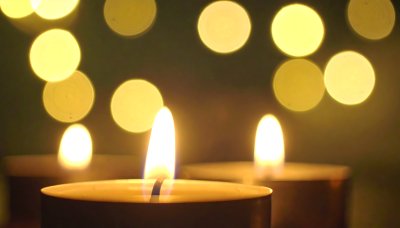 Glowing candles with soft bokeh creating peaceful atmosphere
