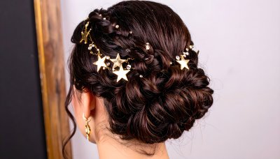 Elegant braided updo with golden stars and crystals, evoking wonder