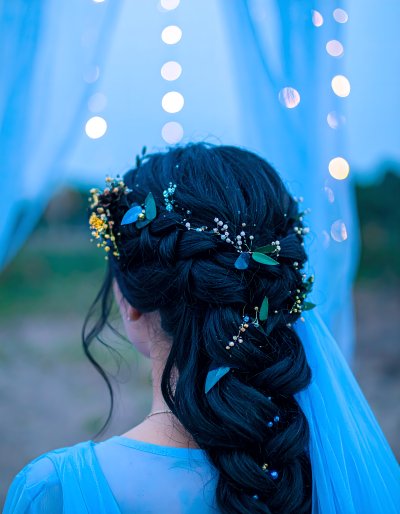 Braided hair, florals, pearls, bokeh lights
