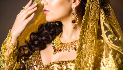Dazzling Indian bride in luxury gold jewelry and intricate embroidery