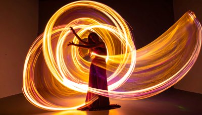 Mesmerizing fire dancer twirls with glowing light trails