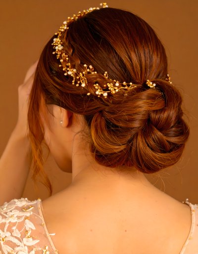 Bride with golden braided updo and pearl hairpiece
