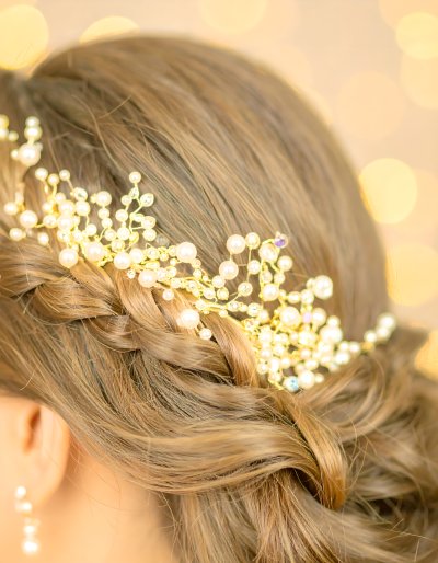 Elegant golden hair accessory with pearls and crystals in a braid