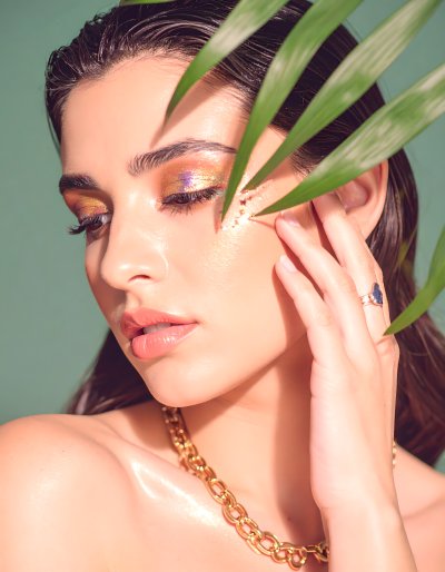 Radiant Beauty with Golden Accents and Tropical Leaves