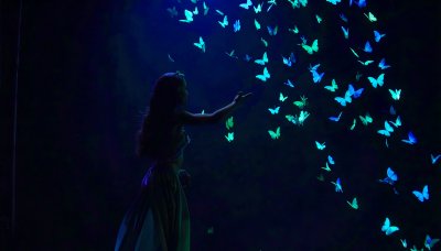 Woman with butterflies on dark green screen for VFX