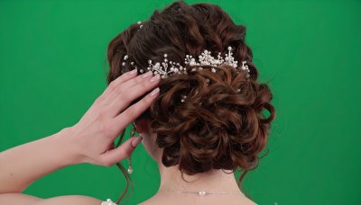 Bride's elegant updo with pearl and crystal hair accessory