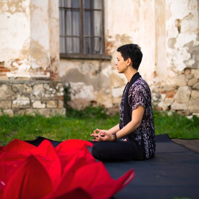 Serene woman meditating outdoors, finding inner peace.