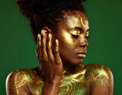 Mystical woman with golden body paint on green screen for compositing
