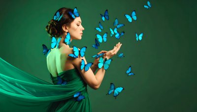 Woman with blue butterflies on green screen for fantasy compositing