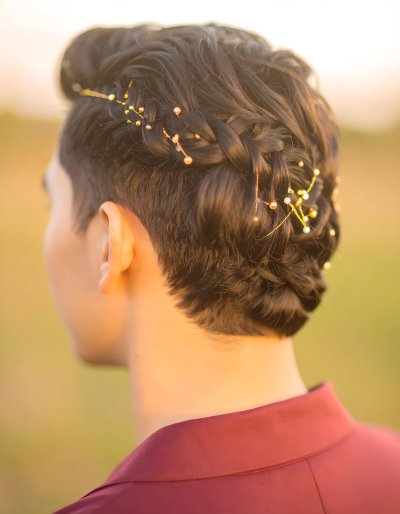 Elegant braided hair with gold and pearl accents, exuding luxury.