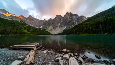 Inspiring mountain vista with serene lake and sunrise glow