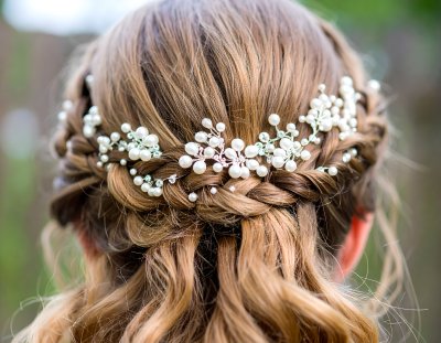 Romantic bridal hairstyle with delicate pearls and sparkling crystals.