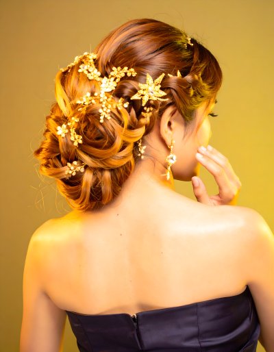 Elegant bride's updo with golden floral hair accessories