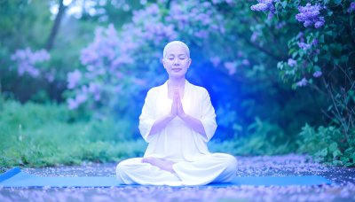 Serene woman meditating in a garden with blooming lilacs