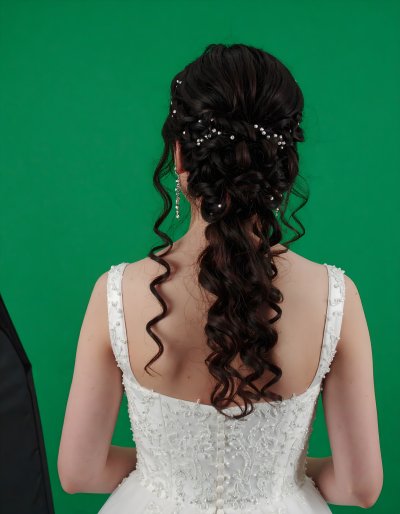 Bride with updo and curls on green screen for compositing