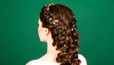 Braided updo with pearl accents on green screen for compositing