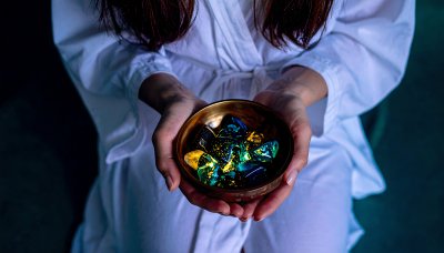 Mystical glowing crystals in hands, ethereal and enchanting