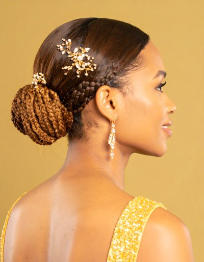 Elegant woman with jeweled hairpins and gold dress