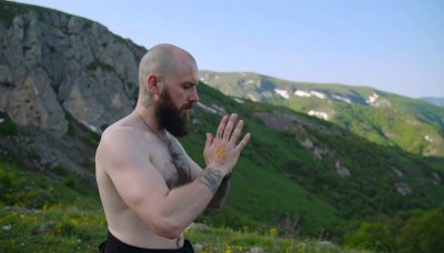 Meditative yogi on mountain with green screen compositing option