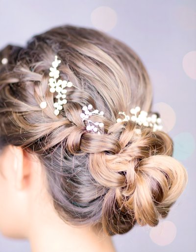 Elegant braided updo with pearls.