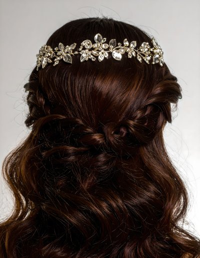 Sparkling crystal and pearl hair accessory on braided dark hair