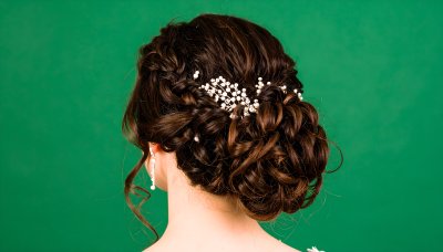 Elegant updo with braided hair and pearl accessory