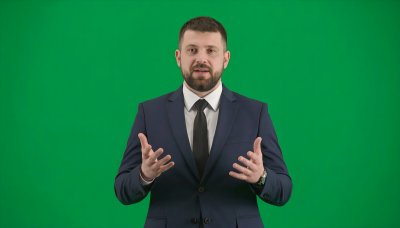 Empowering business leader presenting on green screen for compositing