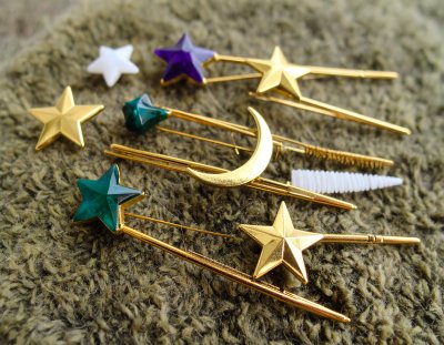 Celestial hair accessories: stars, moon on textured green background