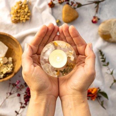 Hands cradle glowing orb, botanicals, serene, mystical