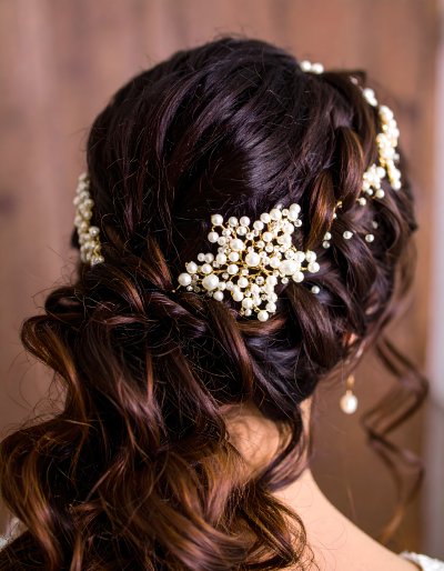 Elegant bridal updo with sparkling pearl and crystal hair accessories
