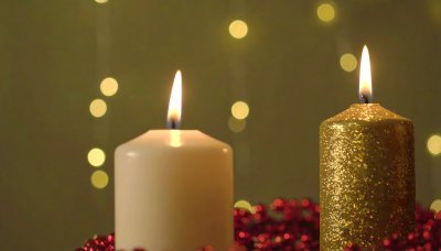 Glowing candles and red garland creating a festive atmosphere