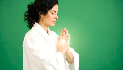 Meditating woman on green screen for wellness content