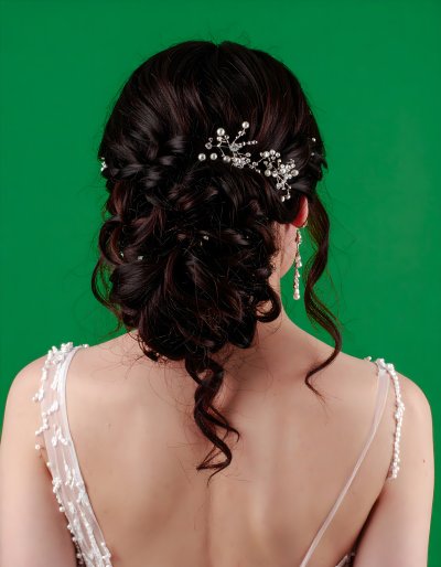 Bride with braided updo and crystal hairpiece on green screen