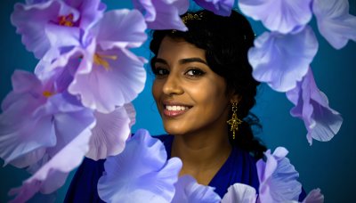 Ethereal woman with purple flowers, radiating wonder