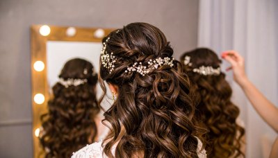 Elegant bridal updo with floral hairpiece